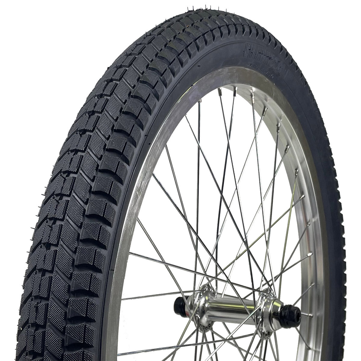 S&M Mainline 20-inch BMX tire with directional tread pattern mounted on a silver spoked wheel.