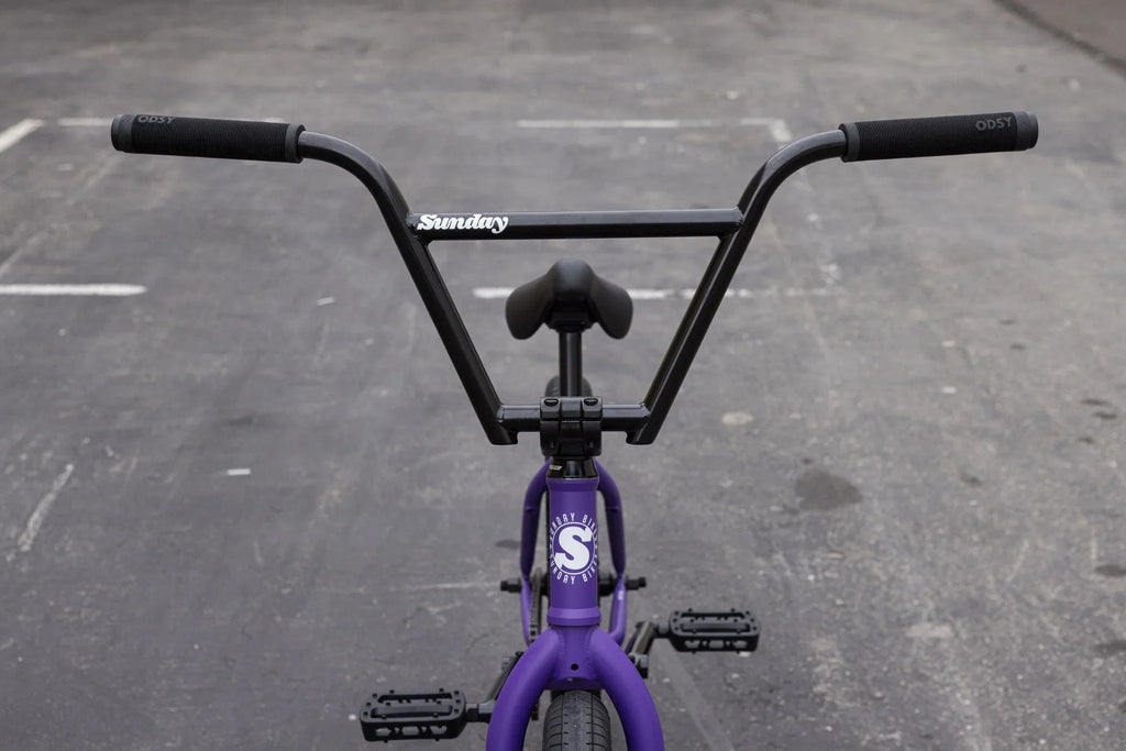 Matte Grape Soda Sunday Forecaster BMX bike with black 4-piece handlebars and chromoly frame.