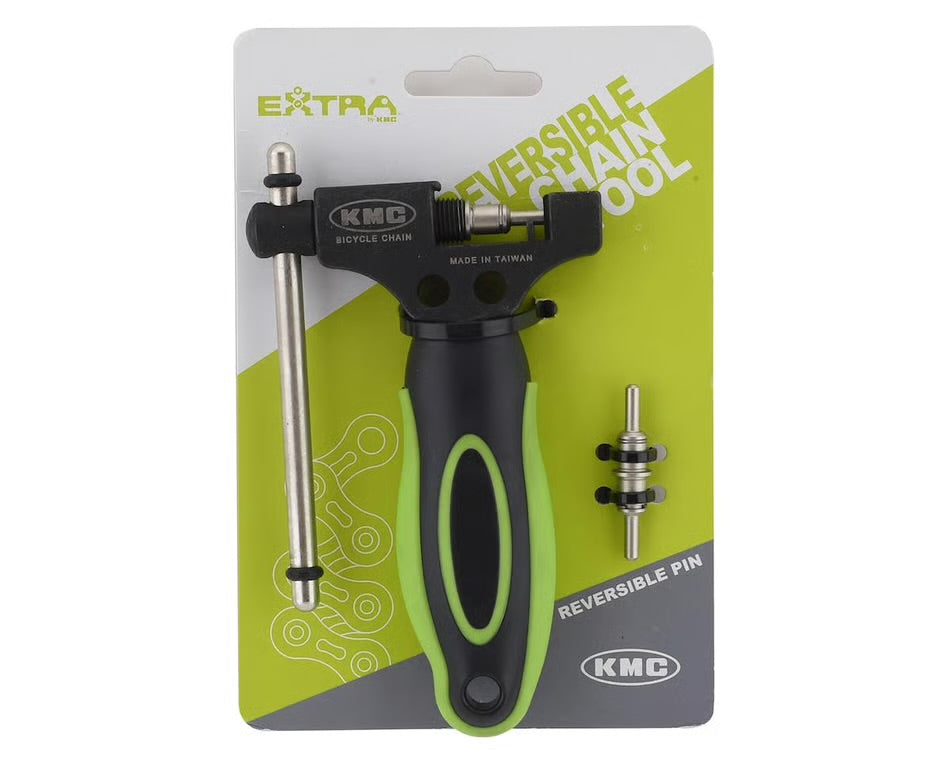 KMC reversible bicycle chain tool with a black and green ergonomic handle, metal breaker pin, and spare pin on retail card.