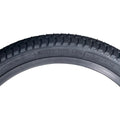 Black S&M Mainline 20-inch BMX tire with directional tread and micro-knurled surface texture.