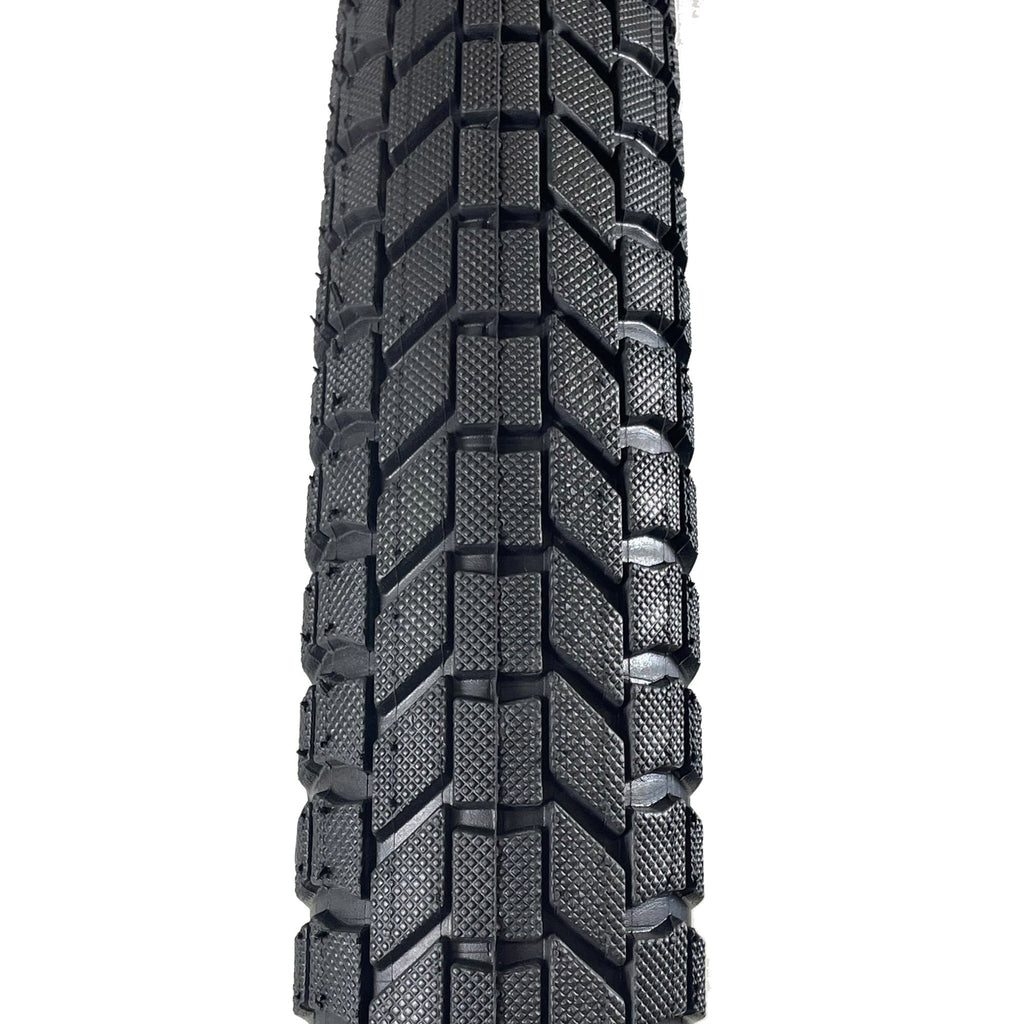 S&M Mainline 20-inch BMX tire featuring a black directional tread pattern with micro-knurled blocks for trail and street use.