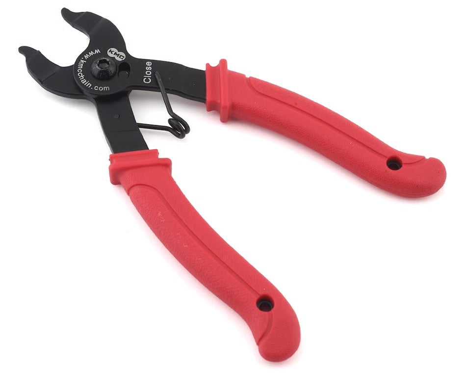 Black KMC Missing Link chain pliers with ergonomic red rubberized handles and a spring-loaded closing mechanism.