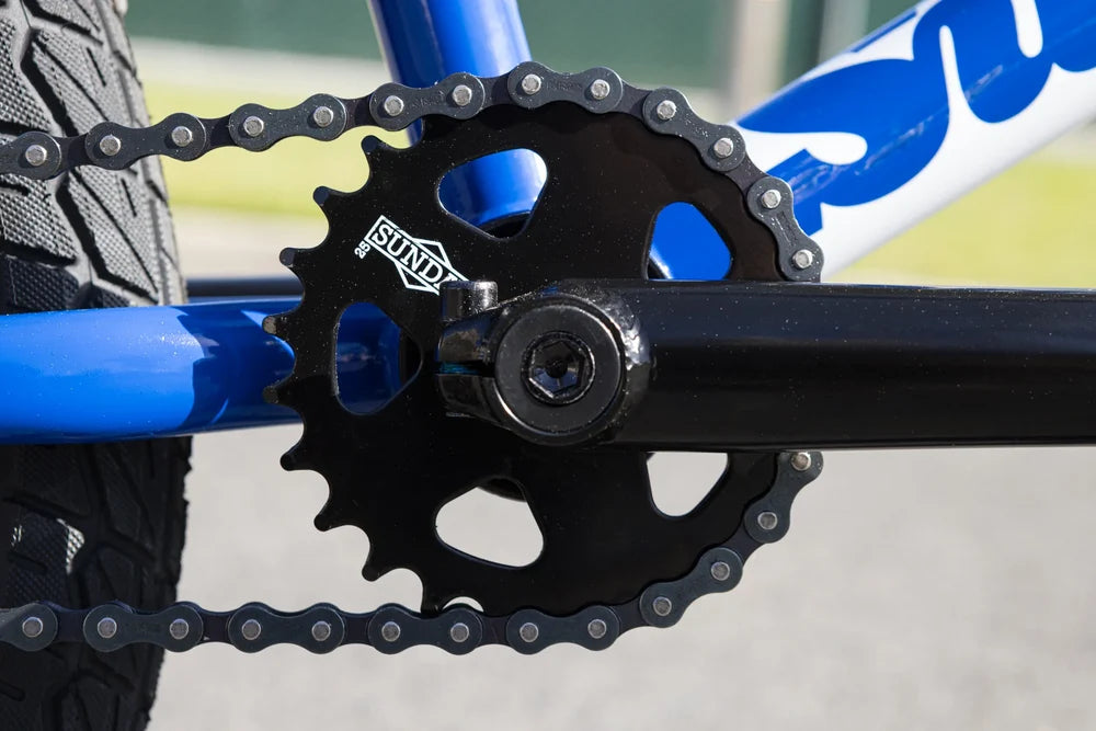 Gloss Sunday Blue BMX frame with black Sabretooth v2 sprocket, KMC chain, and Current v1 tire.