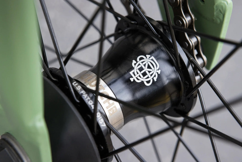 Matte sage green Sunday Forecaster frame with black Odyssey Clutch v2 freecoaster hub and spokes.