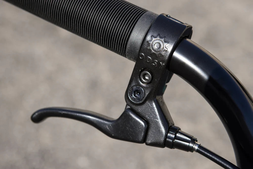 Black Odyssey Springfield brake lever and ribbed grip on a Sunday Scout BMX bike handlebar.