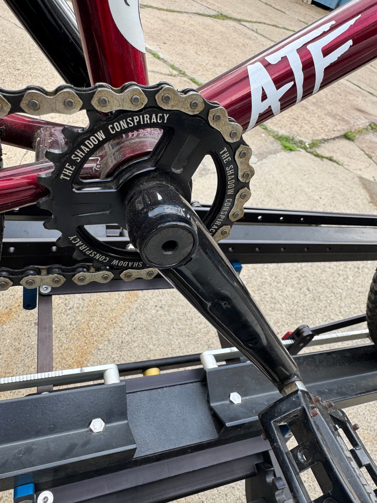 Trans red S&M ATF BMX frame with black Profile cranks and The Shadow Conspiracy sprocket.