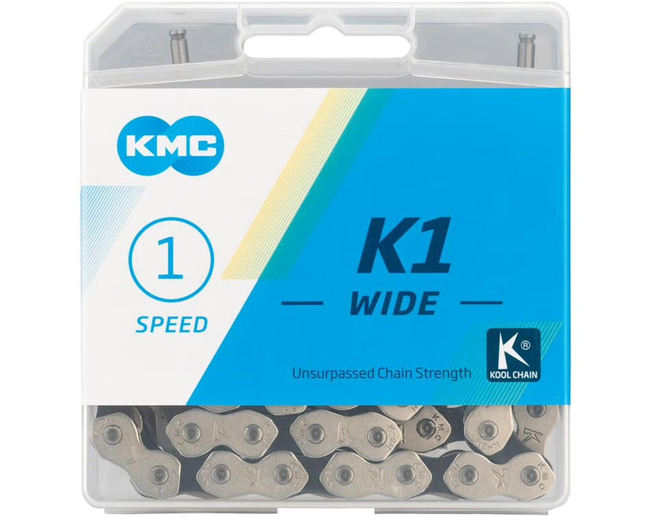 KMC K1 Wide single-speed bicycle chain with silver and black links in clear plastic retail packaging.