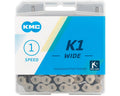 KMC K1 Wide single-speed bicycle chain with silver and black links in clear plastic retail packaging.