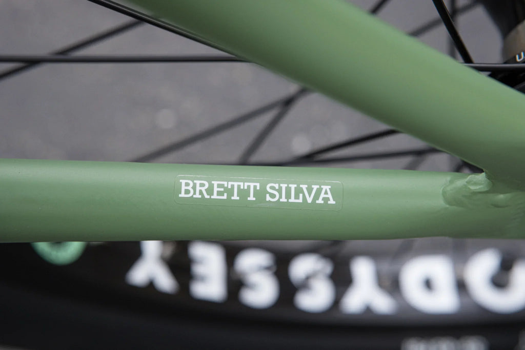 Matte sage green chromoly frame of a Sunday Forecaster Brett Silva signature BMX bike with Odyssey branding.