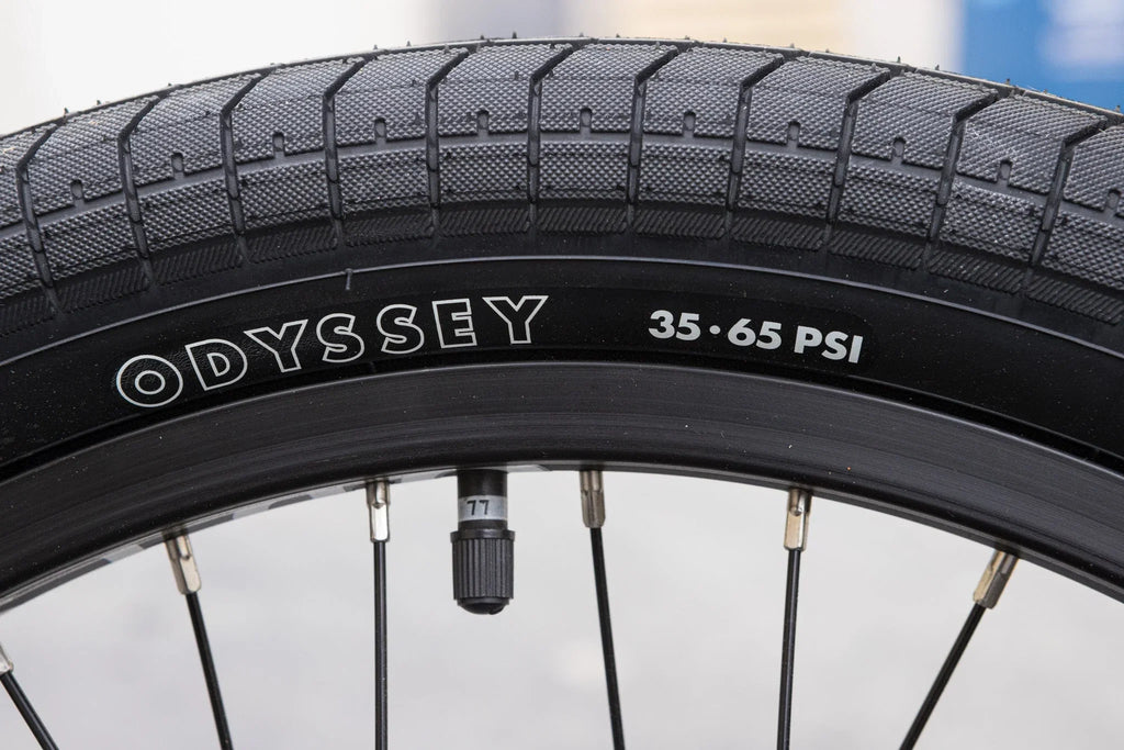 Odyssey Path Pro tire on a black rim with 35-65 PSI rating on a Sunday Forecaster BMX bike.