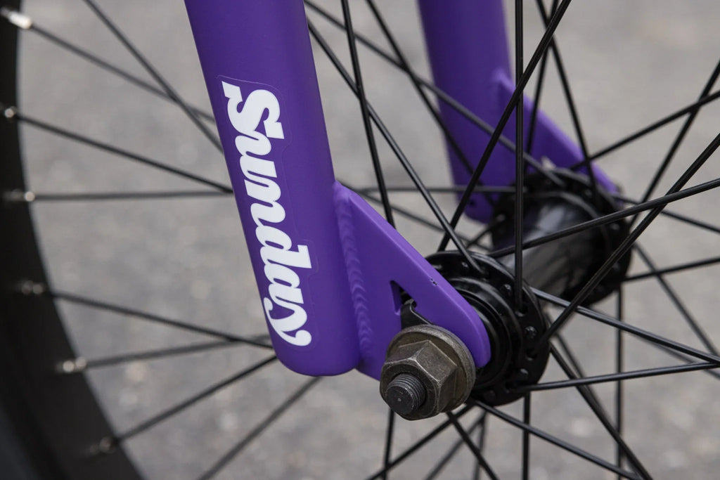 Matte Grape Soda purple Sunday Forecaster BMX fork with black spokes and hub.