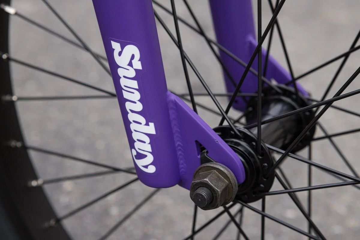 Matte Grape Soda purple Sunday Forecaster BMX fork with black spokes and hub.