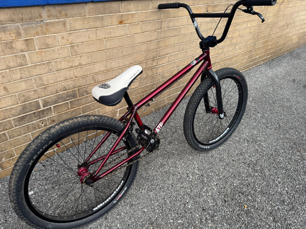Pre-owned S&M ATF 24-inch BMX bike in trans red with white Mirra tribute seat, black components, and Alien Nation rims.