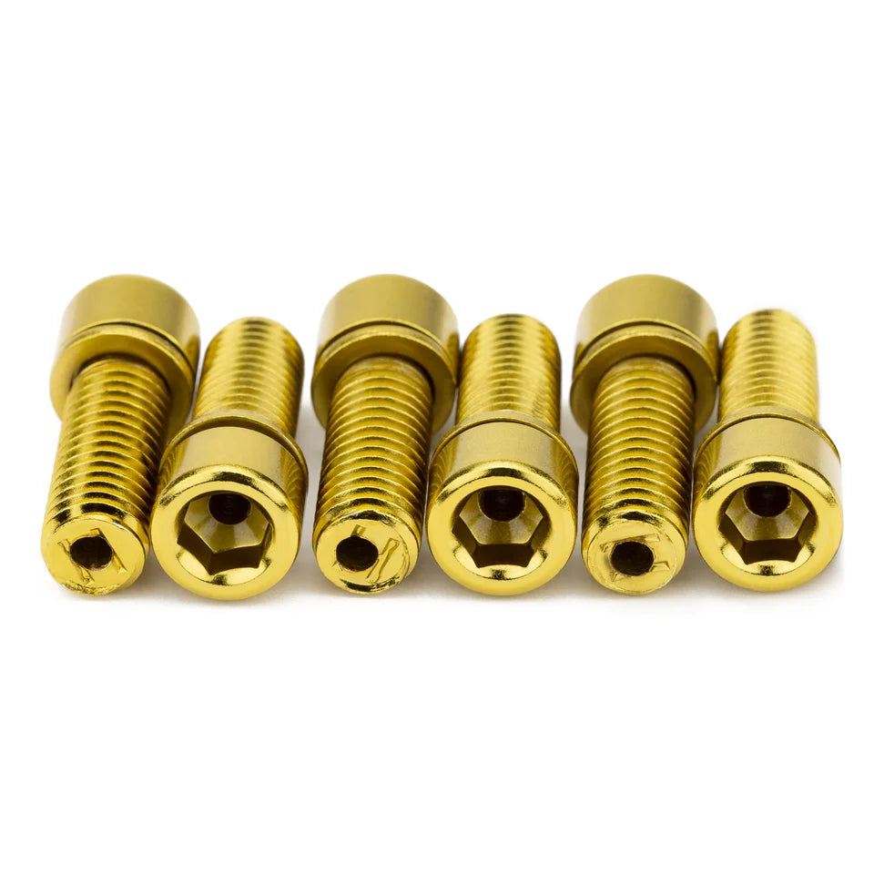 Six gold-colored hollow BMX stem bolts with 6mm hex heads and M8 threads arranged in a row on a white background.
