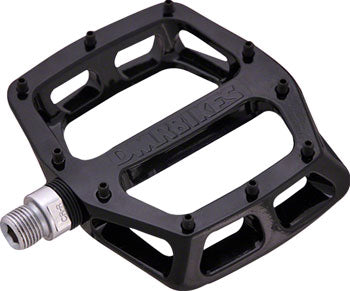 Black DMR V12 aluminum platform mountain bike pedal with concave body and replaceable grip pins.