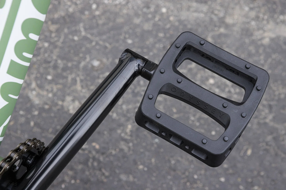 Black Odyssey Twisted Pro pedal attached to a chromoly crank on a matte sage green Sunday Forecaster BMX bike.