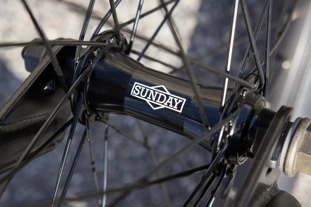 Black Sunday BMX bike hub with branded logo, black spokes, and sealed bearings on a 20-inch wheel.