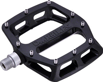 DMR V12 magnesium platform pedals in black with a concave body, replaceable pins, and a 9/16-inch chromoly spindle.