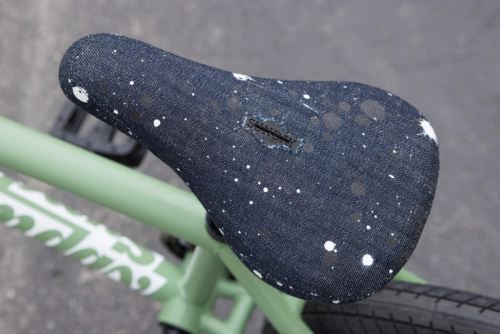 Sunday Silva pivotal seat with denim splatter pattern on a matte sage green chromoly BMX frame.