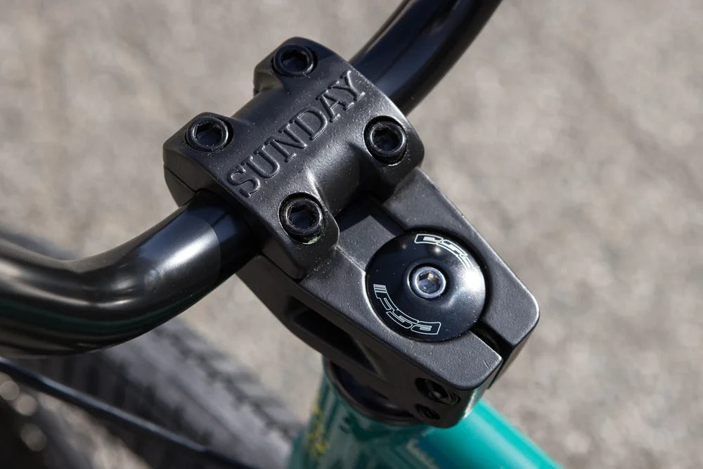 Black Sunday Freeze top load stem and FSA headset cap on a gloss pine green Sunday Scout BMX bike frame.