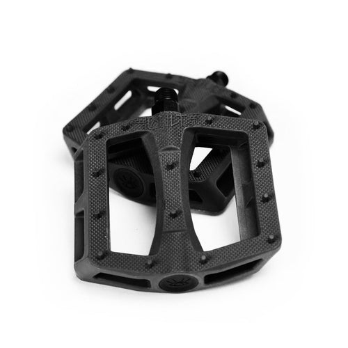 Black Cult Dakota Roche signature BMX pedals with a slim profile, knurled surface, and molded grip pins.